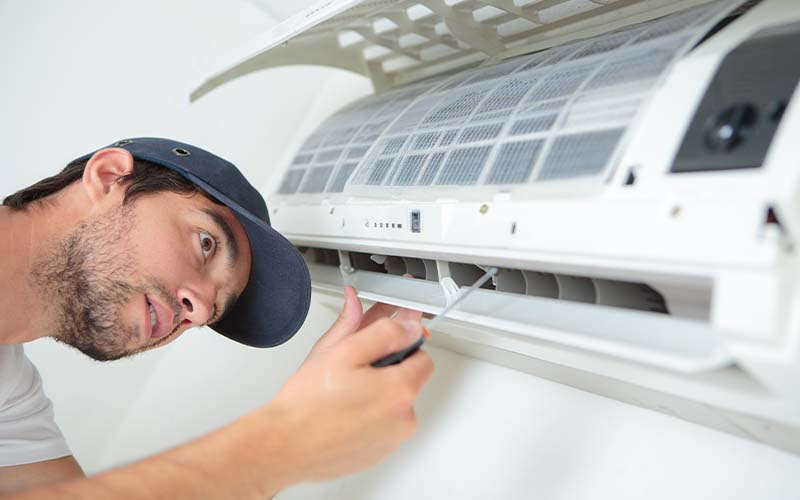 Man installing air conditioning unit